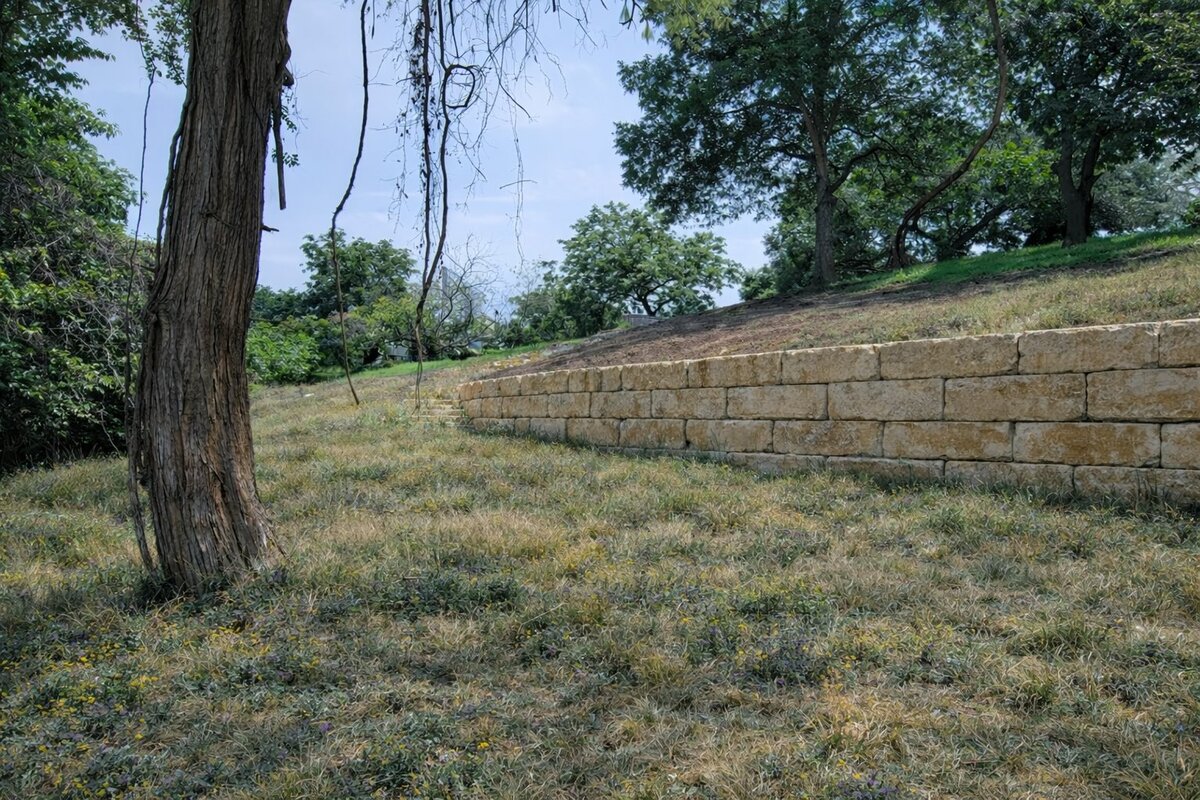 Hill Country limestone retaining wall using quarry blocks in Canyon Lake Texas